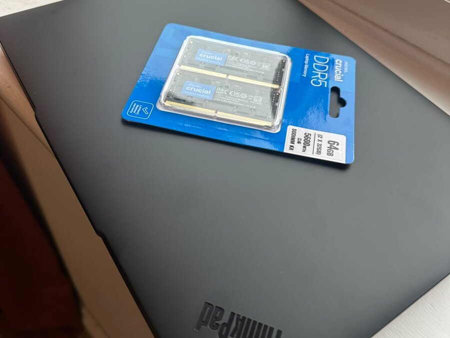 ThinkPad L14 with the Crucial 64GB DDR5 RAM kit on top, London rooftops through the window